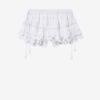 Puria korta skort i bomull med volanger och blommig spets Puria korta skort i bomull med volanger och blommig spets