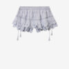 Puria korta skort i bomull med volanger och blommig spets Puria korta skort i bomull med volanger och blommig spets